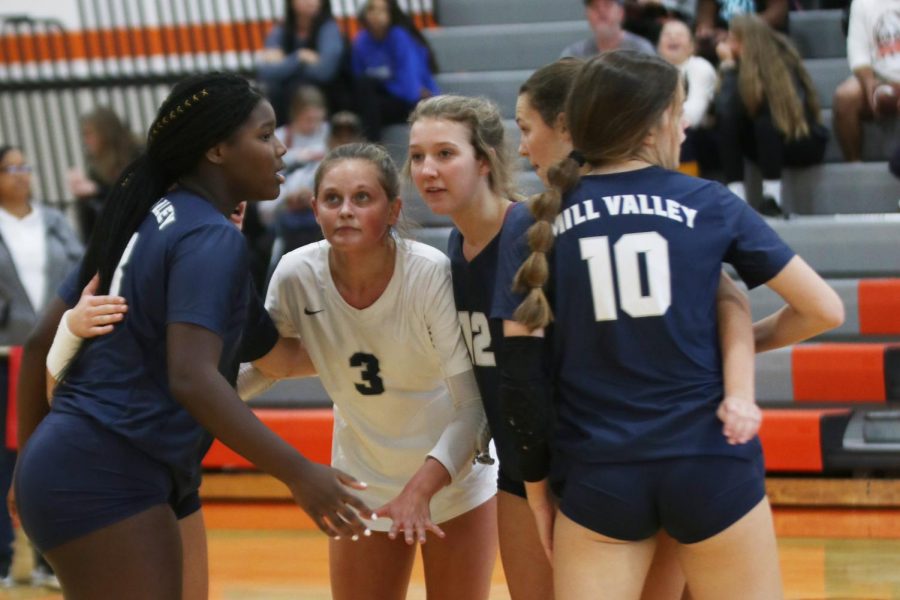 After a point is scored, the Jags gather together in a huddle before the next serve.