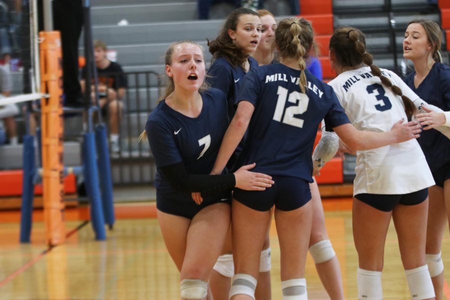 Emerging from the huddle, sophomore Sydney Fiatte yells back to the sideline during the Jags’ first set against Olathe Northwest Saturday, Oct. 26. 