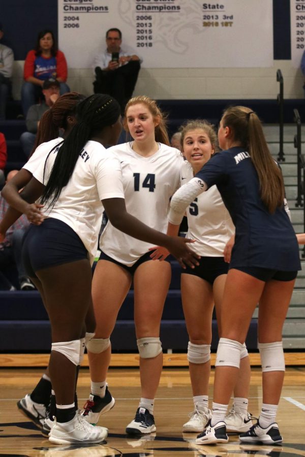 Gathering in a huddle on the court, junior Anna Judd communicates with the team. 