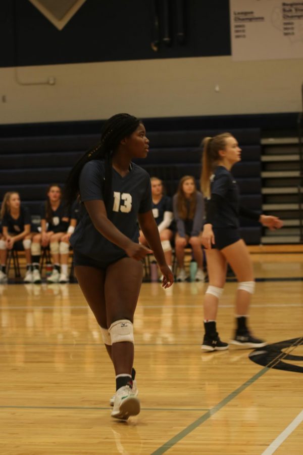 Concentrating, sophomore Taylor Roberts watches the ball as she runs back to her spot.