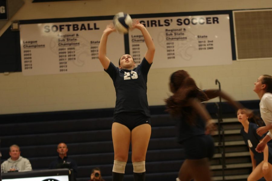 Hands on the ball, junior Carlie Bradshaw sets the ball to her teammates.