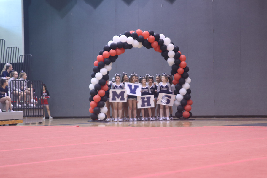 Getting ready for performance, the MVHS cheer team holds out the schools initials.