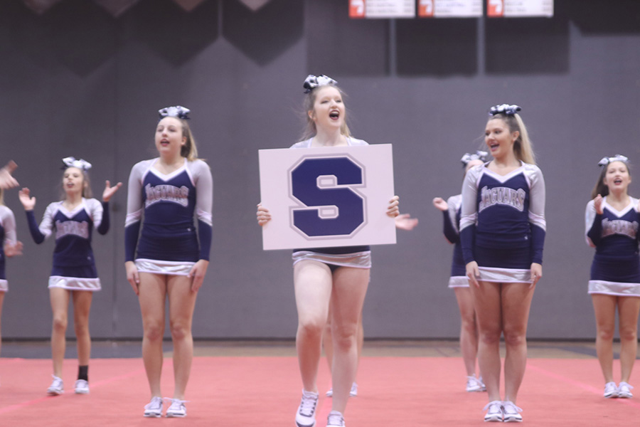 Holding the S with a big smile, senior Sara Petropoulos holds out one of the schools initials.