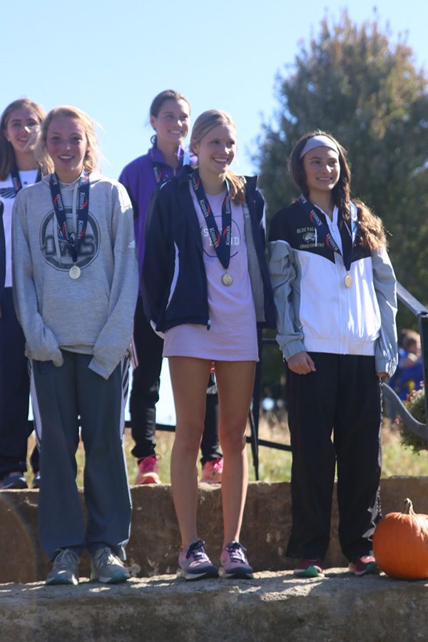 After receiving her second place medal, sophomore Katie Schwartzkopf smiles.