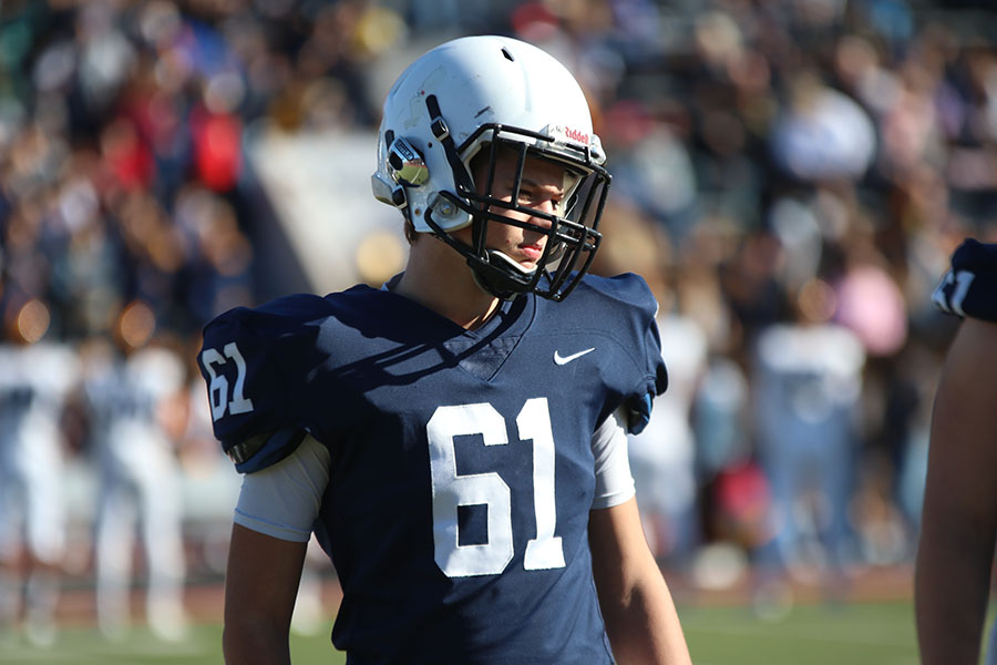 Stepping forward, junior Ethan Kremer follows his teammates off the field. 