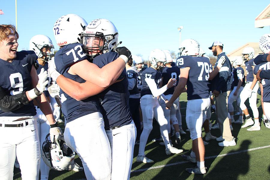 Hugging senior Jack Mcguire, senior Adrien Blazer celebrates after the big win. 
