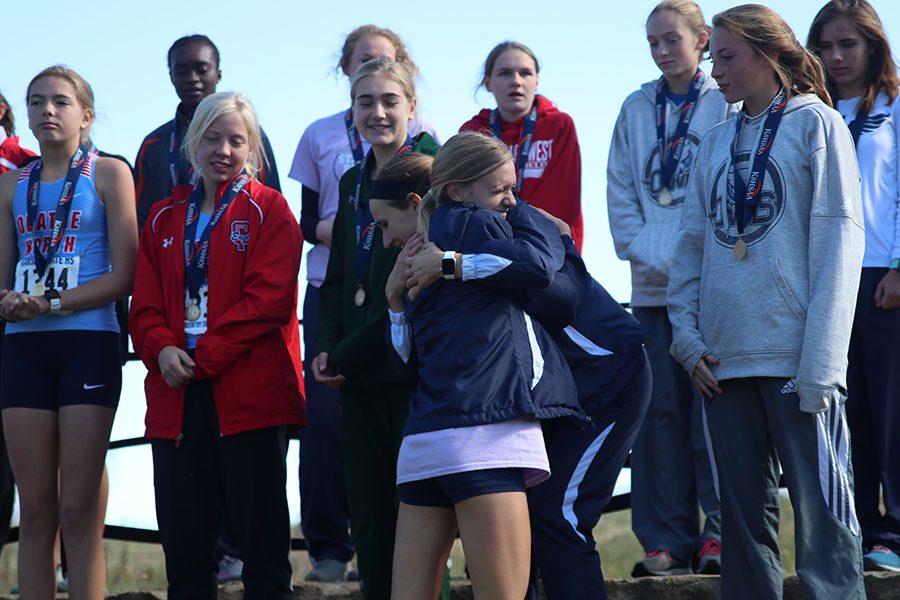 During the girls individual awards, sophomore Katie Schwartzkopf hugs senior Morgan Koca.