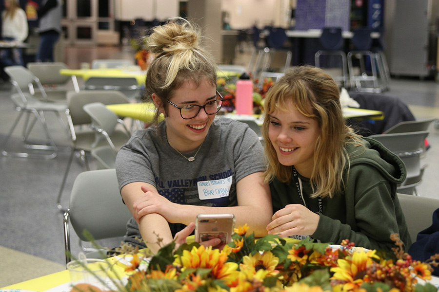 Participating in Quizlet Live at the third annual Clubsgiving held in the commons Tuesday, Nov. 19, sophomore Isabel Travers and junior Makenna Kacsir work as a team to answer the questions.
