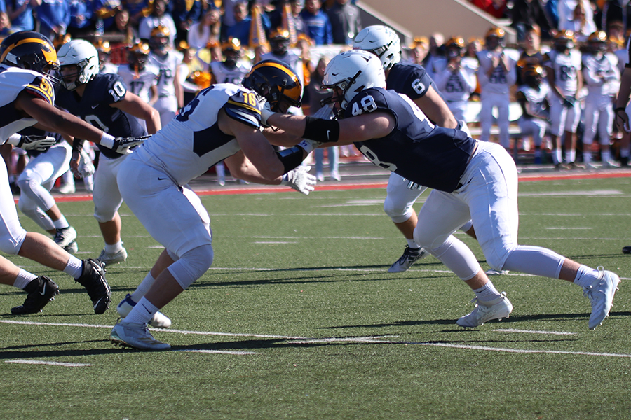 Blocking Wichita NW offender, junior Cole Knappen goes in for a tackle.