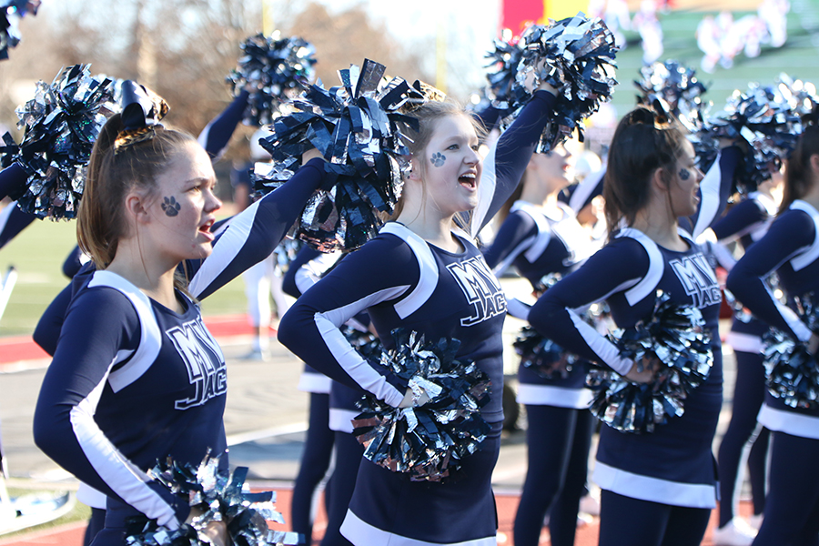 To hype up the crowd, senior Sara Petropoulos chants cheers.