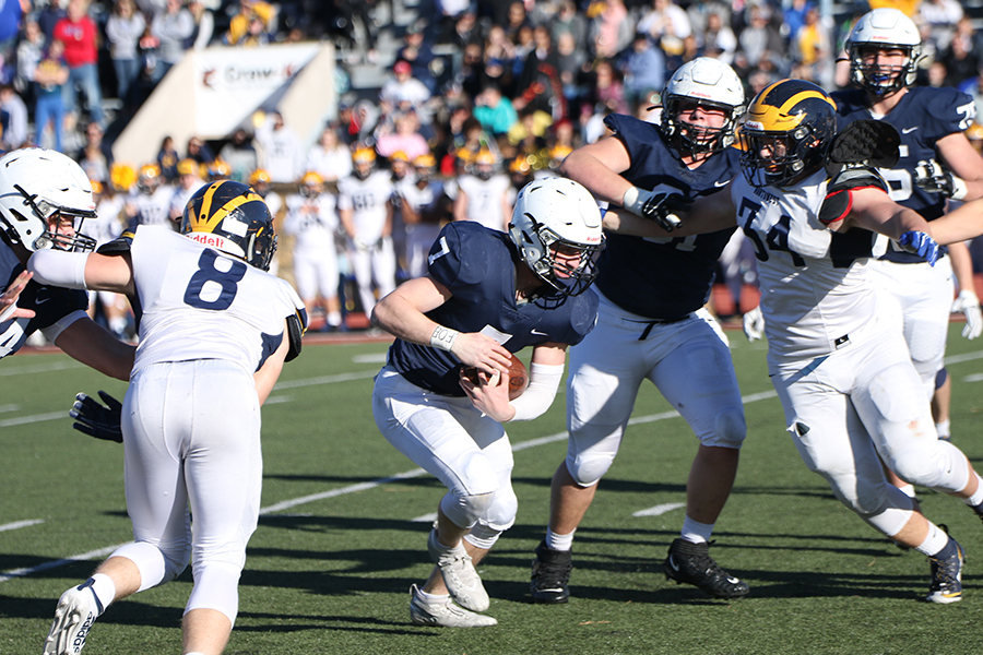 Trying to avoid Wichita NW defense, junior Cooper Marsh runs downfield.