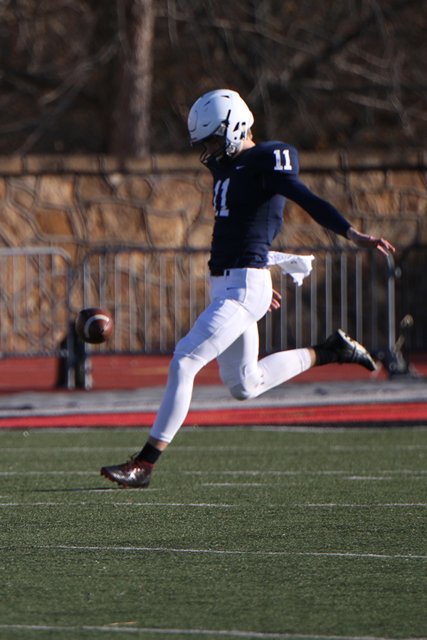 With limited time, junior Chris Tennant punts the ball downfield.