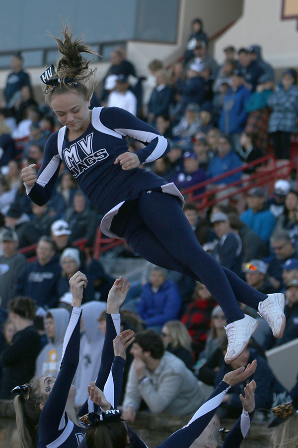 During a jaguar timeout, senior Trinity Ouellette spins in the air. 