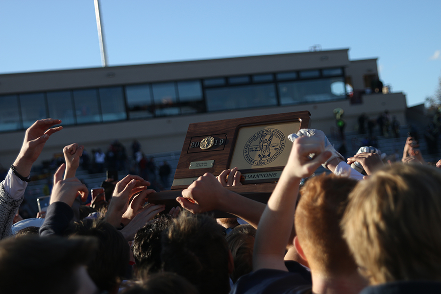 After the victory, everyone huddles around the State Trophy.