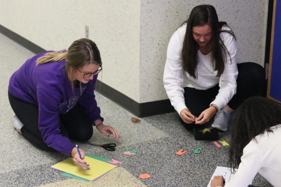 Cutting+out+letters%2C+juniors+Kenzie+Harris+and+Ryleigh+Reigle+create+their+seminar+door+decorations.+Throughout+the+past+couple+weeks%2C+students+participated+in+the+annual+Red+Ribbon+Week+with+this+fun+activity+to+express+the+effects+of+vaping+and+alcohol+on+teens.