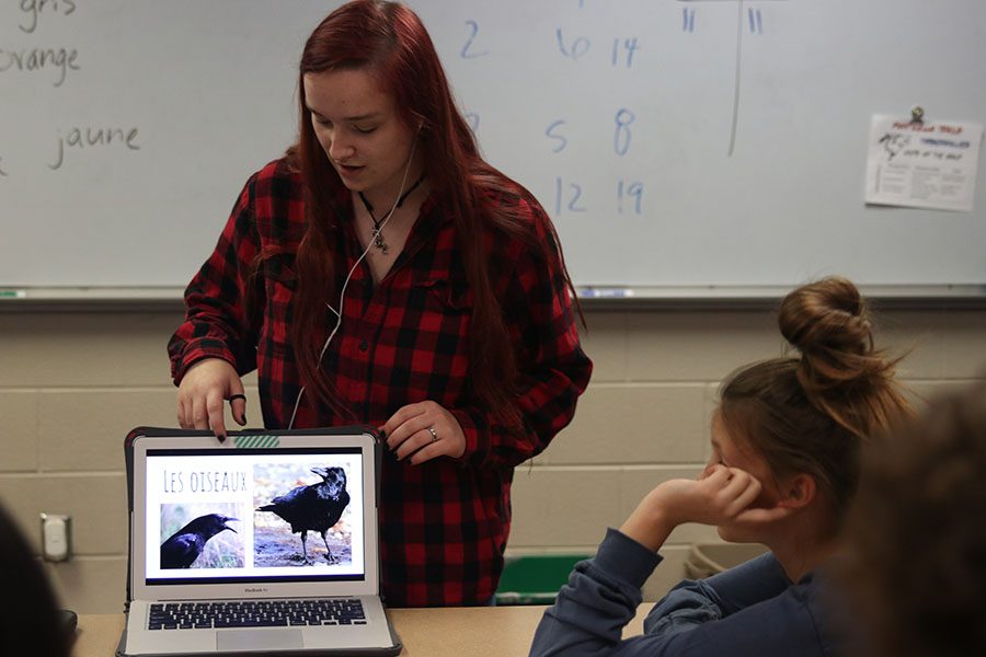 While going through a slideshow on her laptop, junior Austyne January teaches students the French word for bird. French IV and French NHS students travelled to Monticello Trails Middle School Tuesday, November 5.