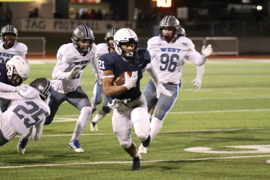 Sprinting down the field, senior Tyler Green helps lead the team to their 42-6 victory against Olathe West Friday, Nov. 8. 

