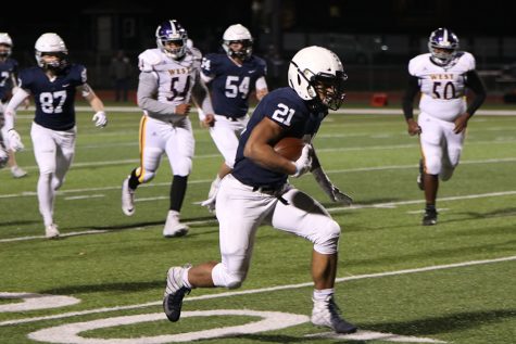 Eyeing a hole upfield, senior running back Tyler Green carries the ball. Green finished the game with 120 yards and 2 touchdowns. 