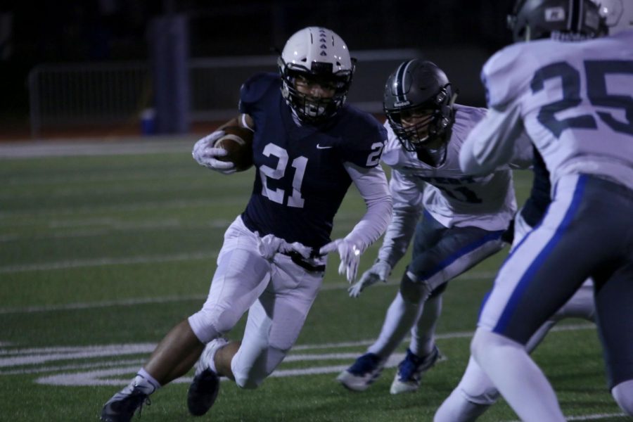 Running down the field, senior Tyler Green dodges the other team.
