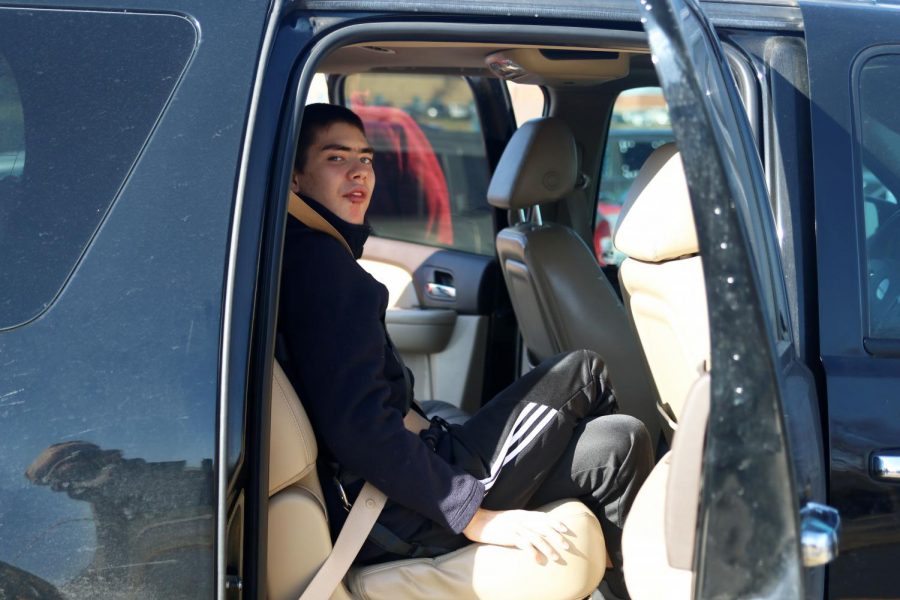 With the harness on, Olathe West senior Ty Hayden sits in the car.