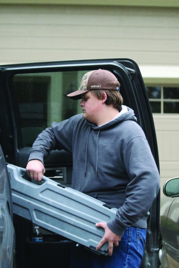 Preparing for the upcoming hunting season, sophomore Ethan Fleming loads his hunting gear into his truck. 

