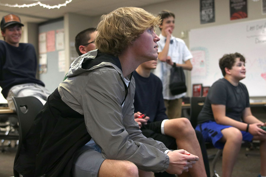 Moving his thumbs on the controller, senior Alexander Heinking attempts to win the game.
