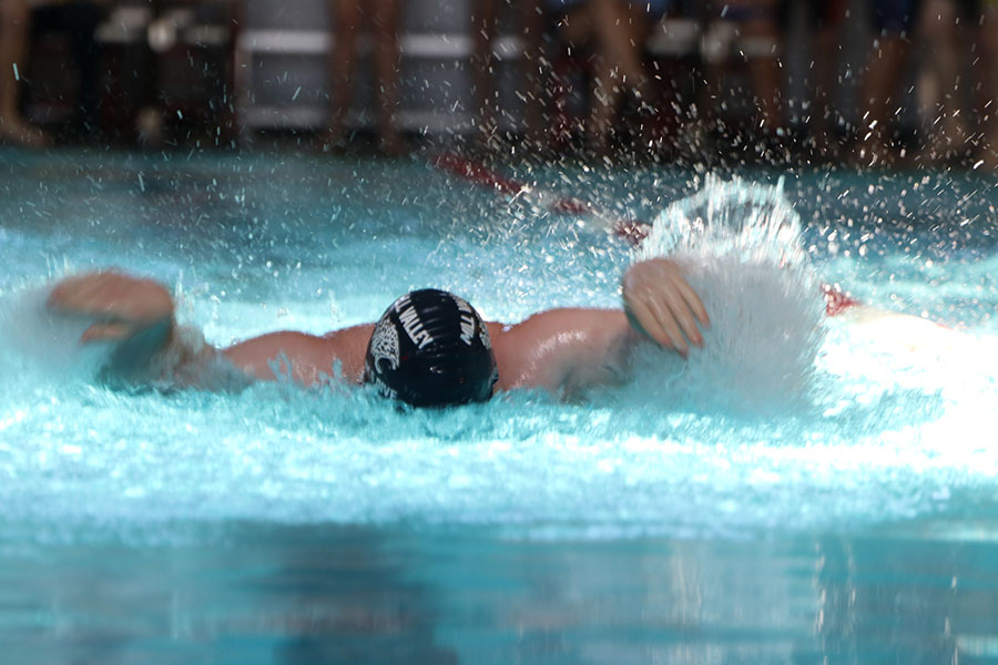 With his head underwater, senior Logan Myers competes in butterfly style relay.