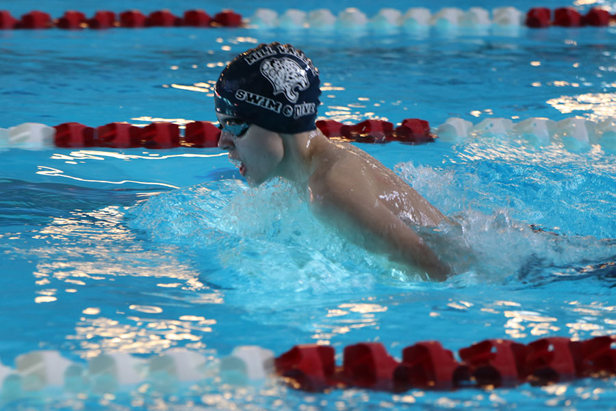 Catching his breath, freshmen Alec Forristal swims in the boys 200-yard breaststroke relay. The team placed fourth at Lansing Saturday, Nov. 4.