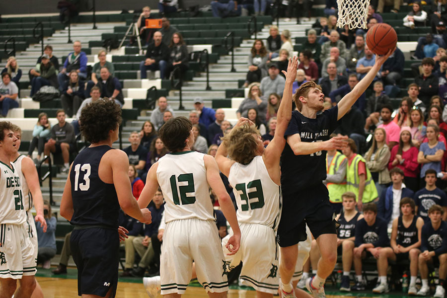 After getting past the defender, senior Braeden Wiltse goes up for a shot. The boys basketball team played in their first tournament of the season with their first competition game being against the De Soto Wildcats, where they defeated them with a final score of 47-42.