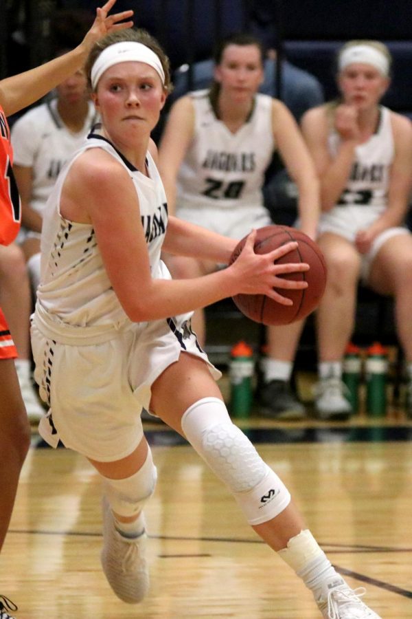 Moving past an opponent, sophomore Emree Zars runs with the ball.