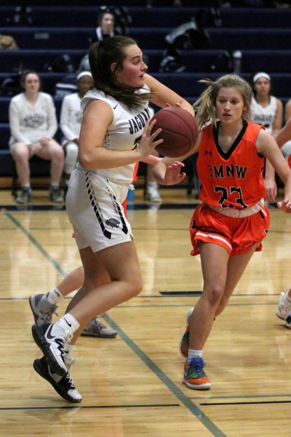 With the ball in hand, junior Payton Oliver passes it to a teammate.