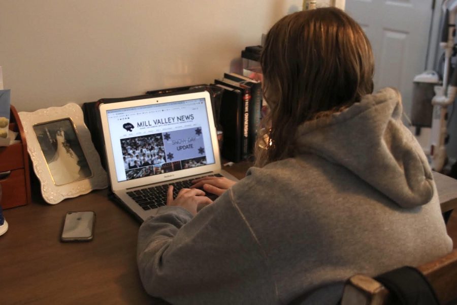 Working on her Macbook, senior Allison Godfrey focuses on her homework at home.