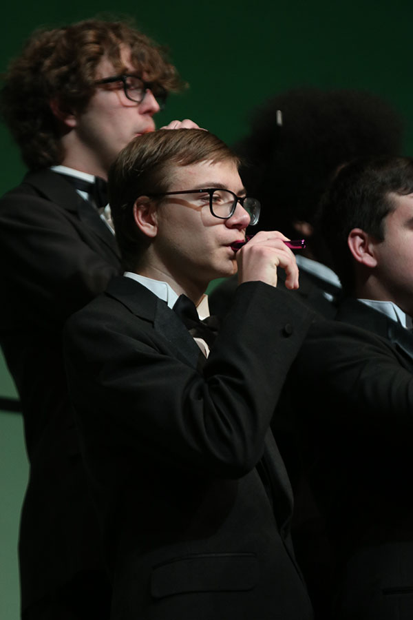 Blowing, sophomore Jackson Raven uses a kazoo.