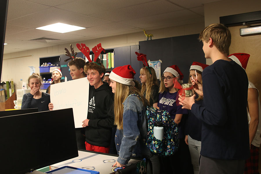 Going around the school caroling, the choir and StucCo members collect money to go toward buying hats and gloves for StuCo’s Adopt-A-Family fundraiser Wednesday, Dec. 4.