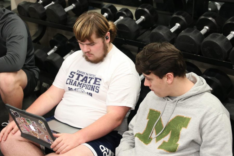 Looking at a laptop, sophomore Theodore Brown and senior Duncan Haines Mills work during study hall.
