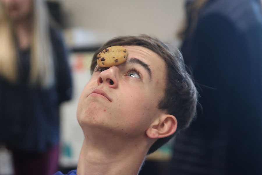 Participating in his classmates Statistic Olympics game, freshman Jack Gilmore balances a cookie on his head Wednesday, Jan. 15.