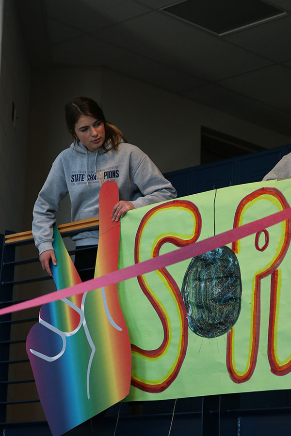 Centering her class sign, sophomore class president Logan Pfeister directs her classmates on Sunday, Jan. 5. 