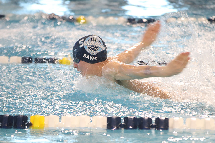 In the third leg of the 200-yard medley relay, junior Mason Davis swims butterfly.
