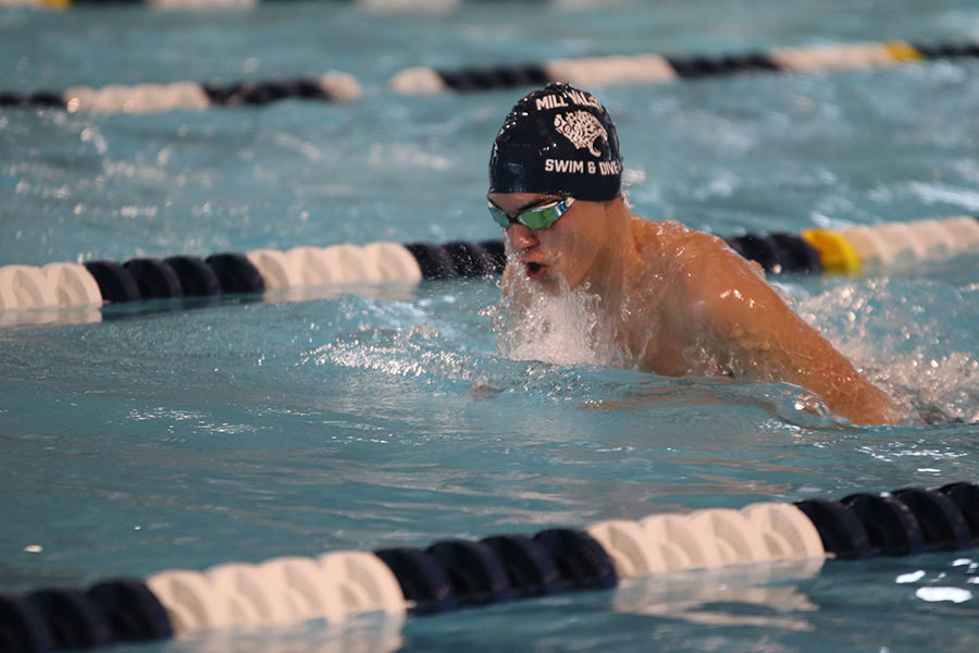 Preparing to turn, junior Cole McClure competes in the 200-yard medley relay.
