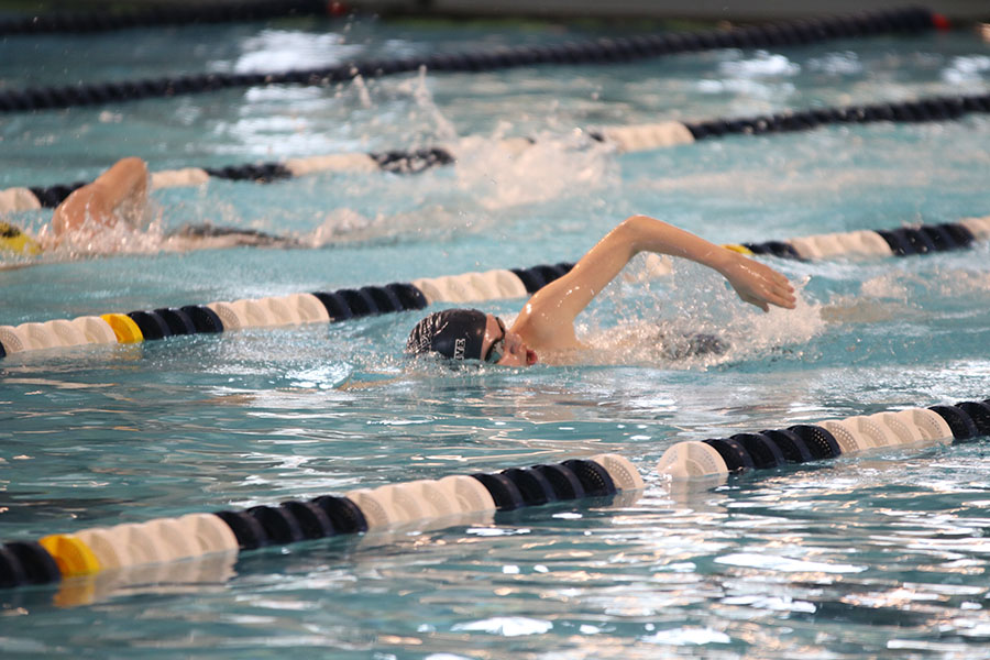 Close to finishing the 200-yard freestyle, freshman Alec Forristal comes up for air.