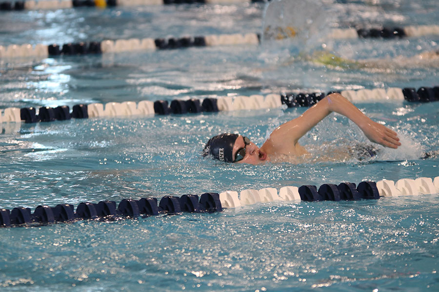 Coming up for air, junior Brady Gabbert swims in the 50-yard freestyle.