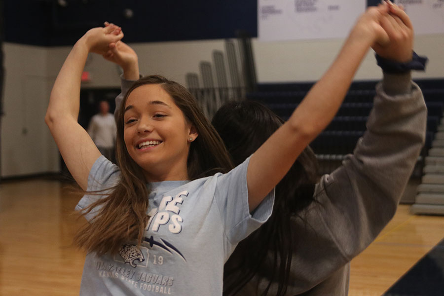 Arms above her head, sophomore Olivia Denney dances with her partner during the StuCo swing dance seminar Wednesday, Jan. 8.