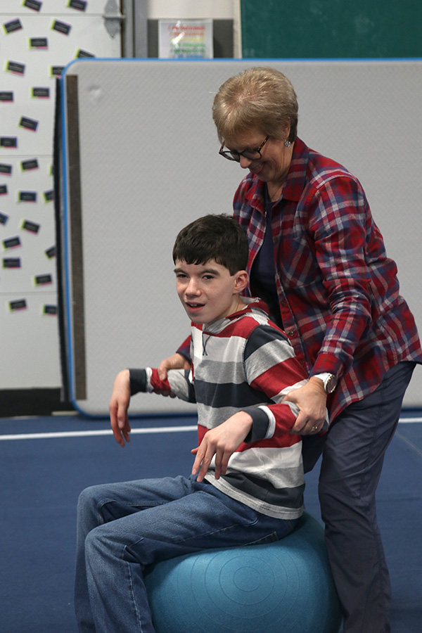 Having fun at Pinnacle Gymnastics, sophomore Jackson bounces on an athletic ball with special educations PE teacher.