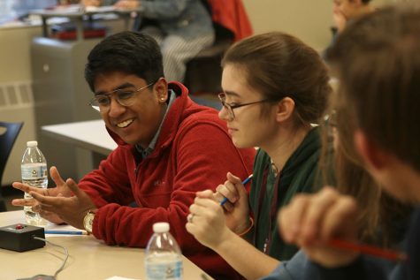 Leaning in, senior Srikar Turaga discusses the question with his teammates. The team went 3-3 during the Quiz Bowl tournament at Lansing Thursday, January 16.