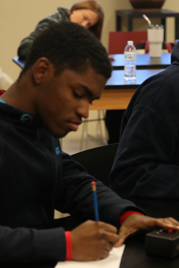 With his finger prepared to buzz in, senior AJ Lee solves a 30 second math question.