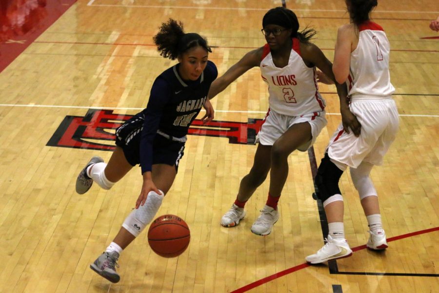 Running past an opponent, junior Vania Barnett dribbles the ball.