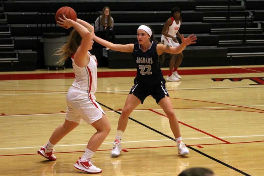Holding out her arms, junior Katherine Weigel guards an opponent.