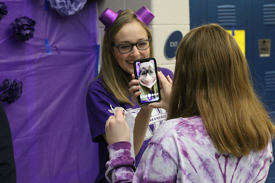 After finishing decorating, freshman Avery Blubaugh and her friend take pictures on snapchat.