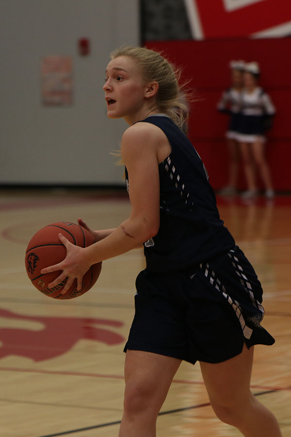 About to pass the ball, freshman Sophie Pringle looks for a teammate.