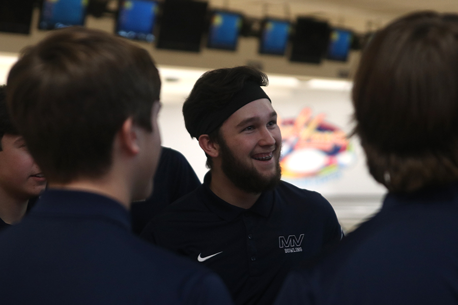 Smiling, junior Simon Hall listens to his teammates during their meet at Park 
Lanes on Thursday, Jan. 23.
